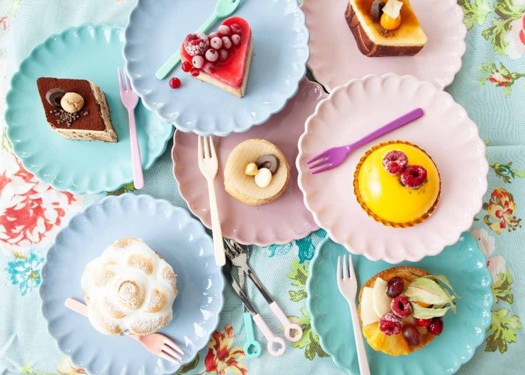 Pratos empilhados contendo diferentes doces e confeitarias